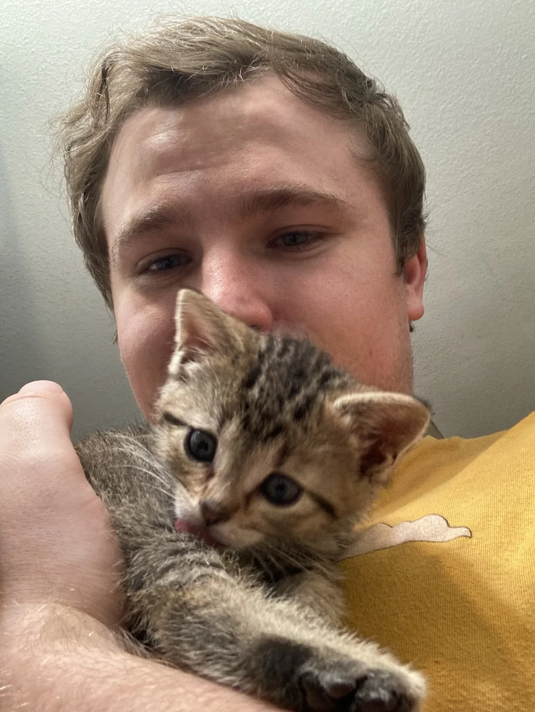 Evan holding a foster kitten.